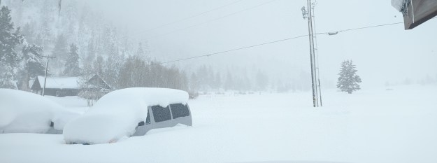 A foggy landscape blanketed in three feet of snow.